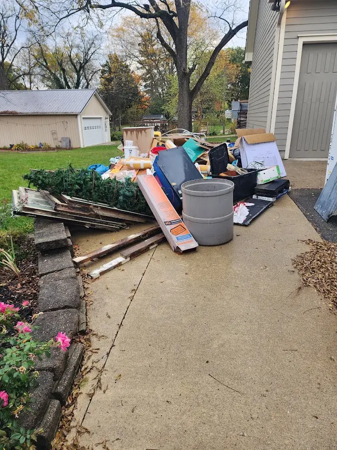 Dumpster being loaded with debris for 10 Yard Dumpster Rental in River Falls